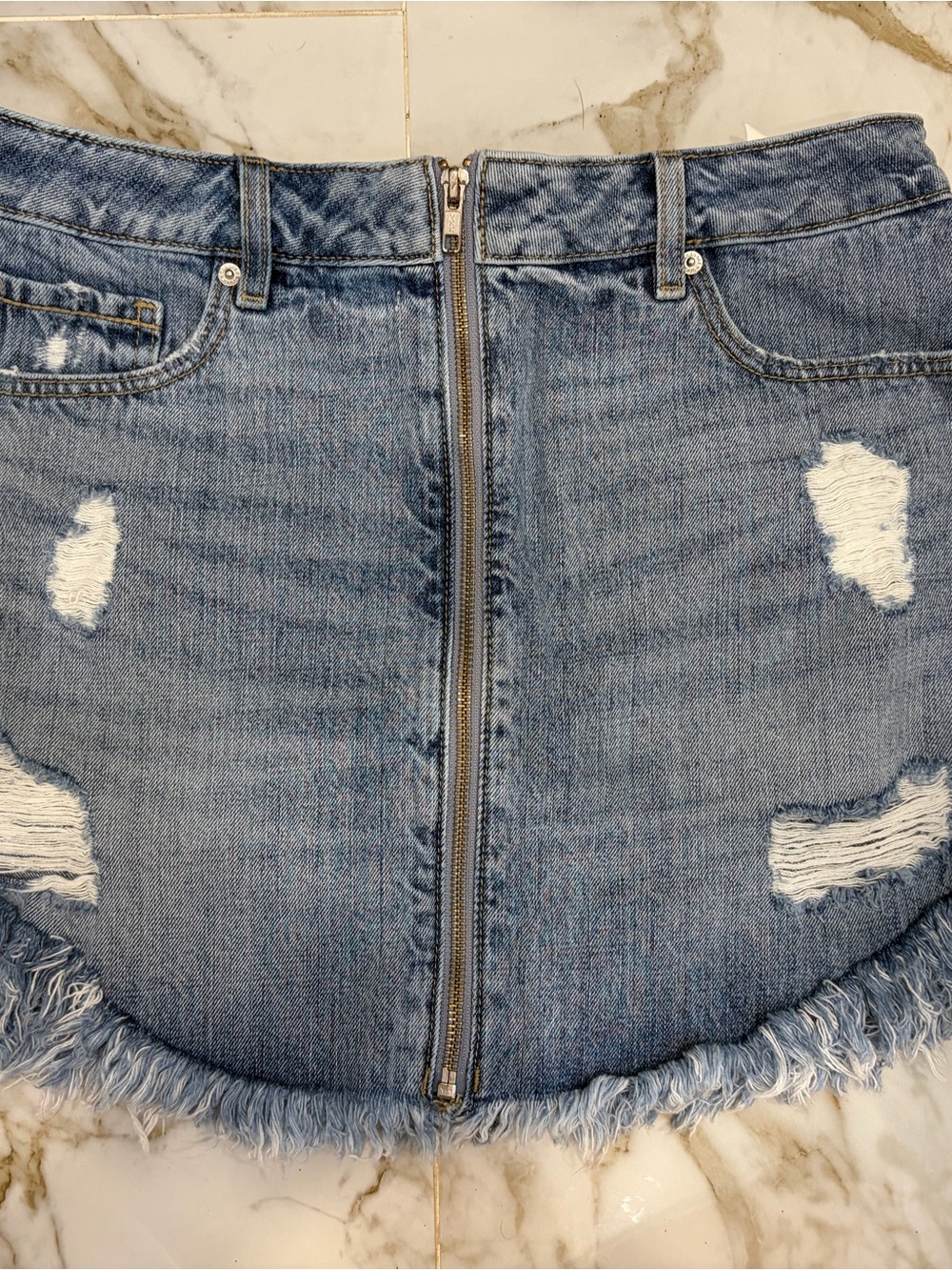 Distressed Light Blue Denim Mini Skirt with Front Zip